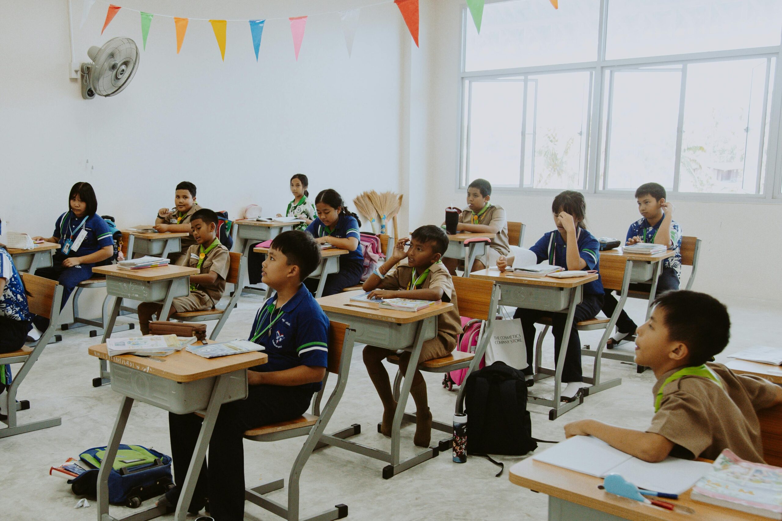 Students attentively participating in a diverse classroom lesson.