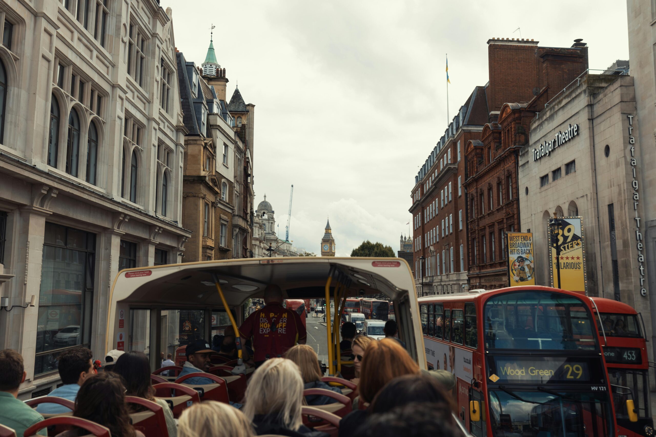 View from a double-decker bus touring central London with Big Ben in the distance.