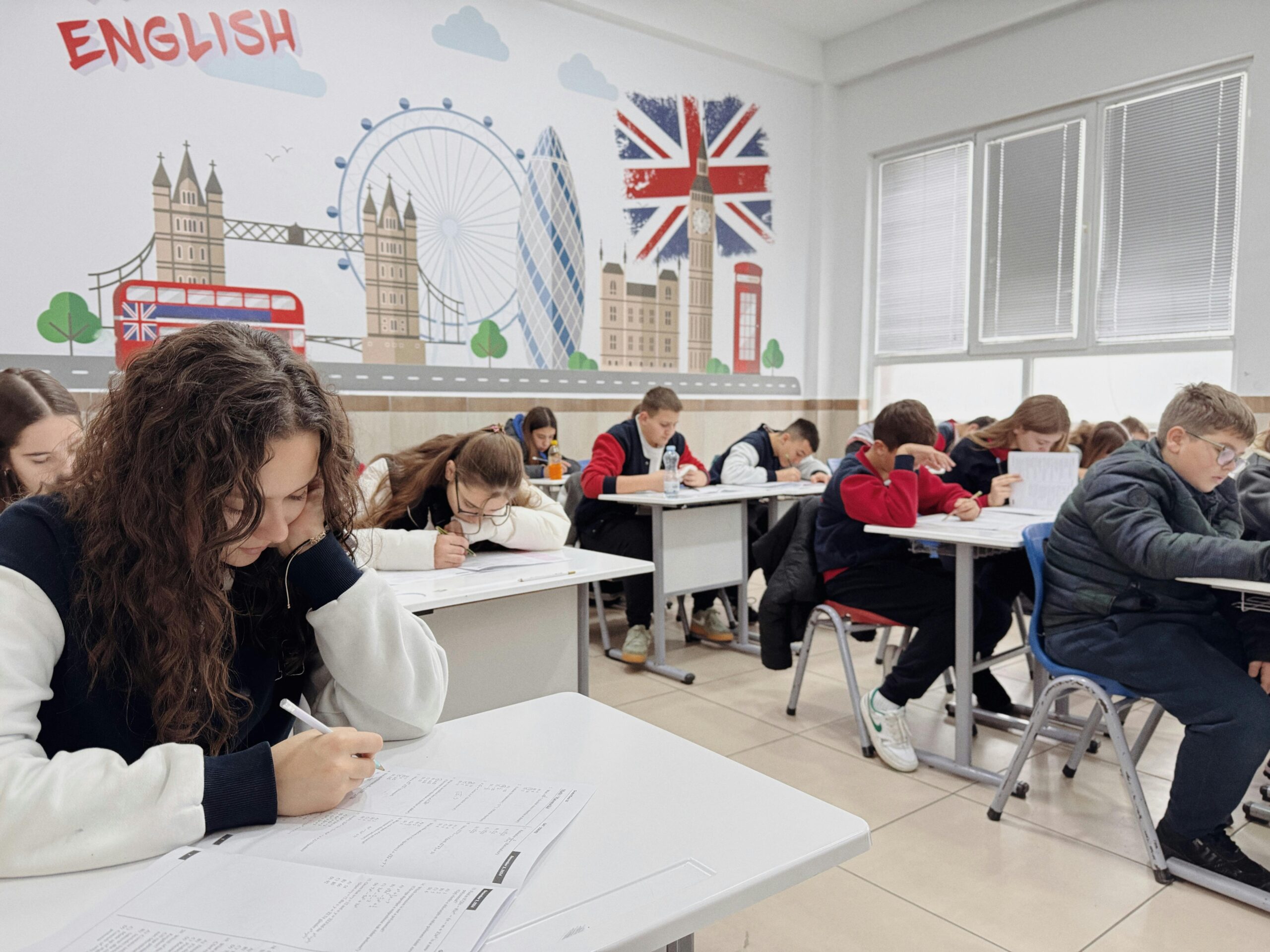 Students focus on an English class study session in a London-themed classroom.